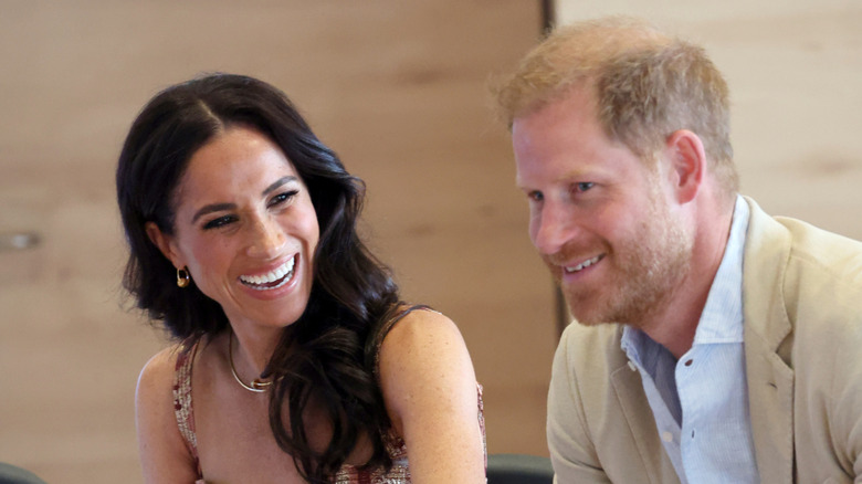 Meghan Markle and Prince Harry laughing together.