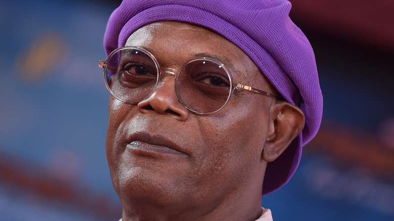 Samuel L. Jackson wearing glasses and purple hat