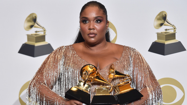 Lizzo holding Grammy awards 