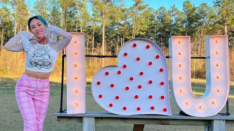 Lizzy Capri poses with "I love you" sign