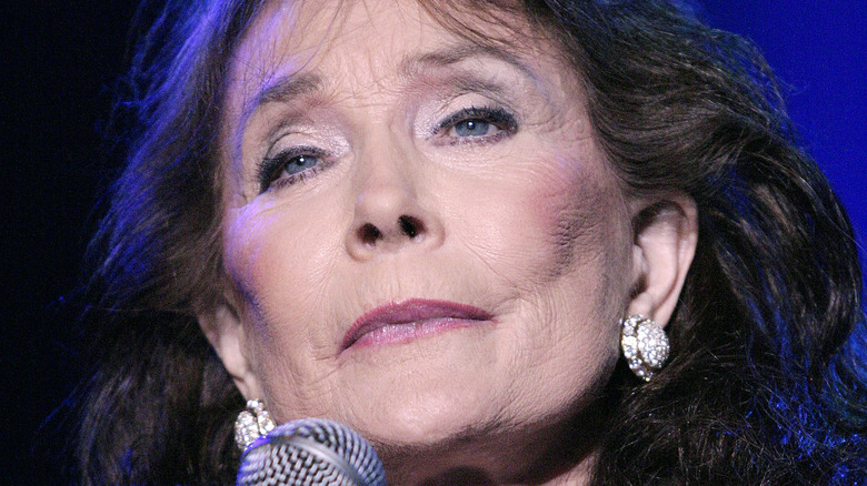 Loretta Lynn performing at a concert 