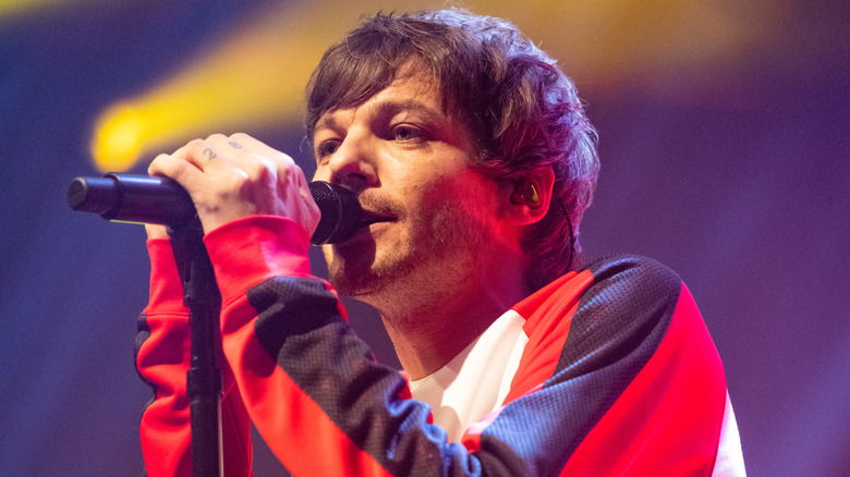 Louis Tomlinson performing on stage