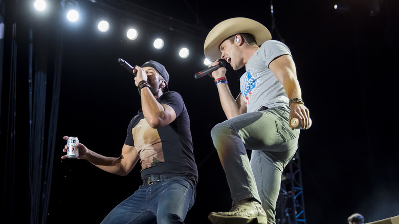 Luke Bryan and Dustin Lynch performing onstage together