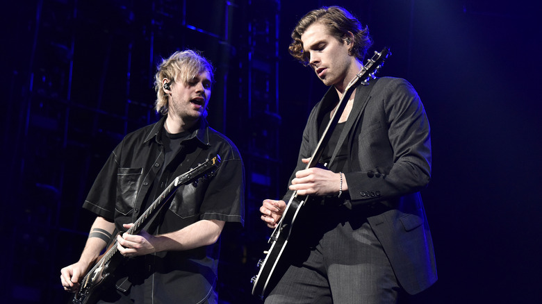 Michael Clifford and Luke Hemmings performing on stage