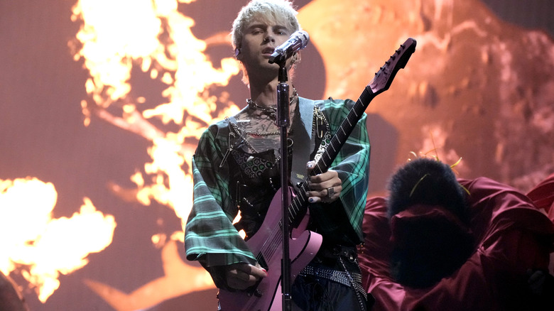 Machine Gun Kelly performs guitar