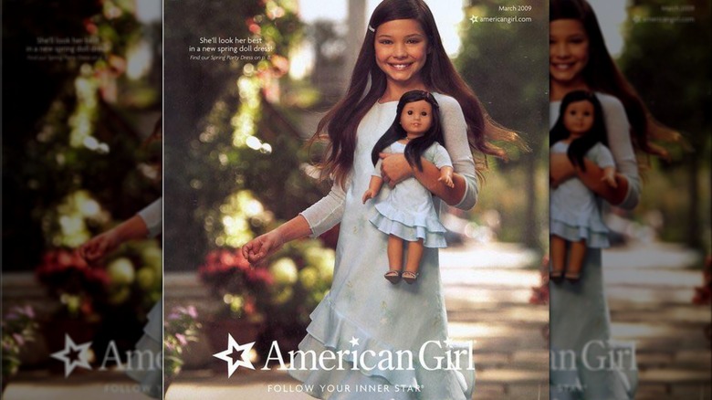 Young Madelyn Cline posing with American Girl Doll