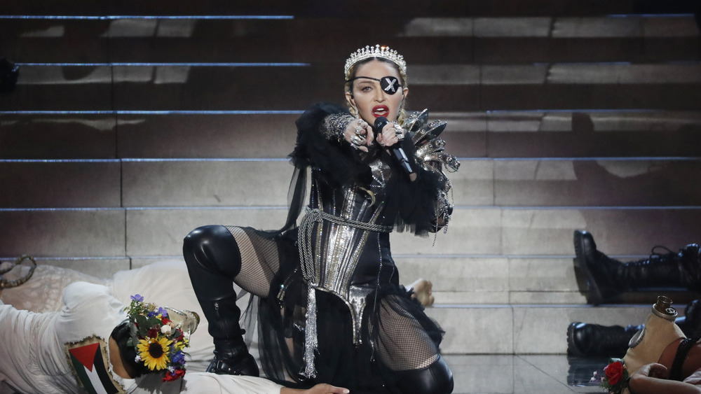 Madonna performing on stage with an eye patch