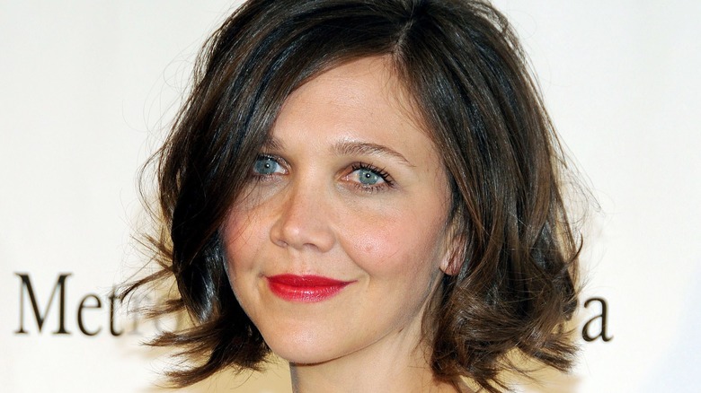 Maggie Gyllenhaal smiles on the red carpet