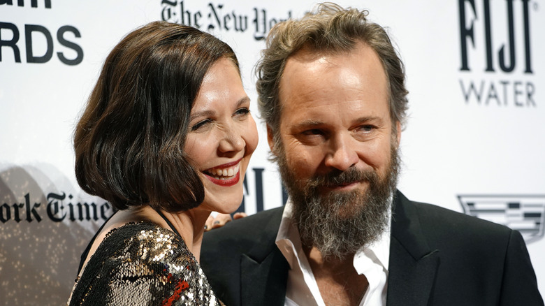 Maggie Gyllenhaal and Peter Sarsgaard smile on the red carpet