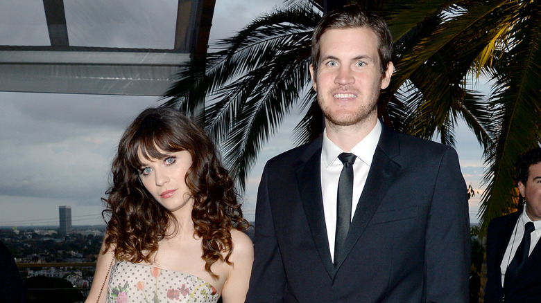 Zooey Deschanel tilting head beside smiling Jamie Linden