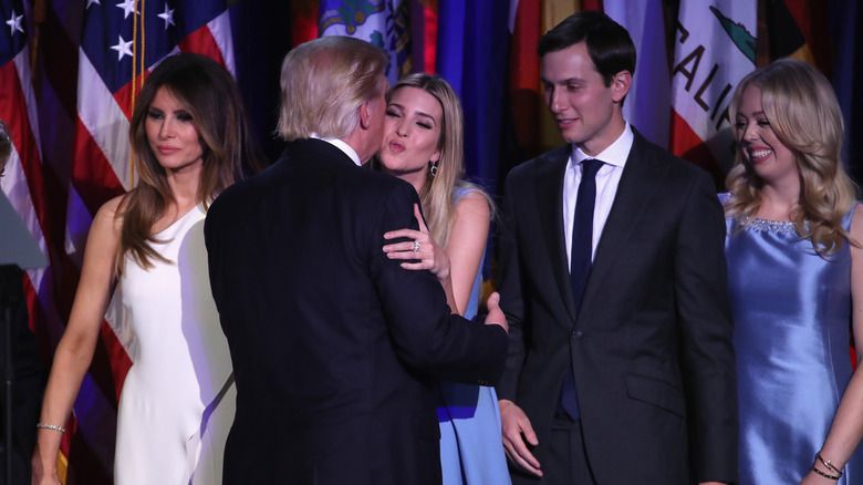 Donald Trump embracing Ivanka Trump on stage with family