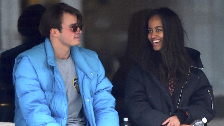 Rory Farquharson wearing a blue winter jacket with Malia Obama wearing a black winter jacket