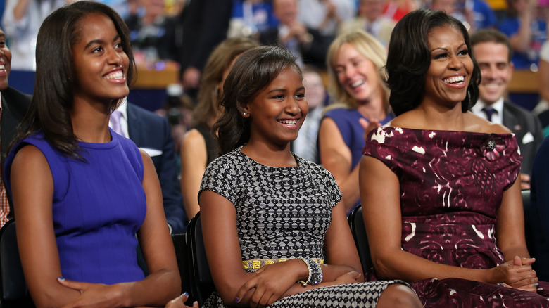 Malia, Sasha, and Michelle Obama smiling