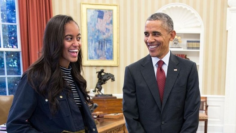 Malia and Barack Obama laughing in Oval Office