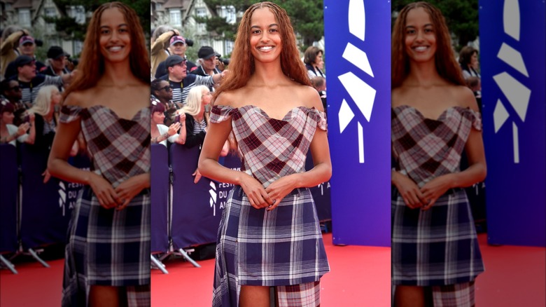 Malia Obama red posing in plaid outfit