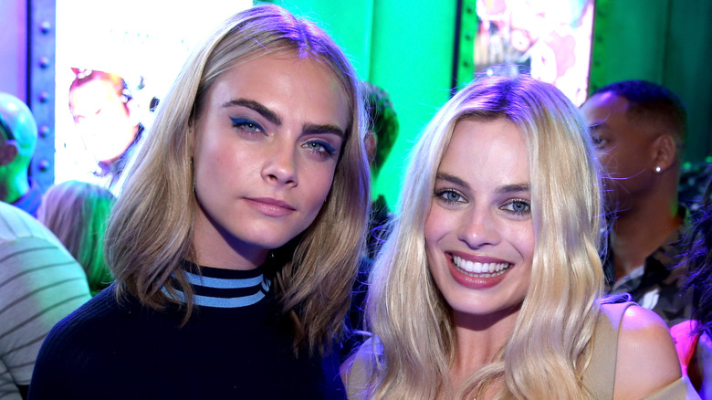 Cara Delevingne and Margot Robbie pose at event