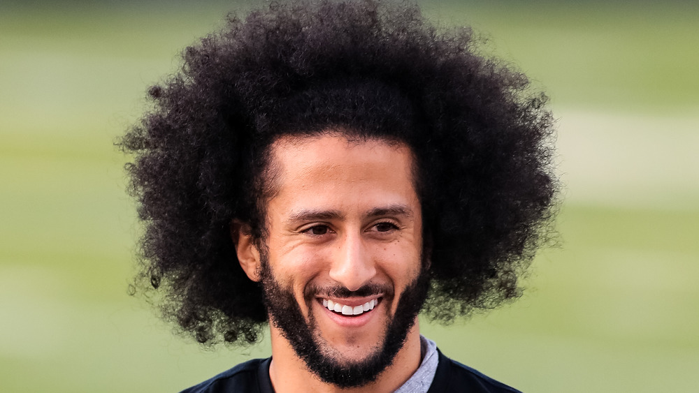 Colin Kaepernick smiling on a football field