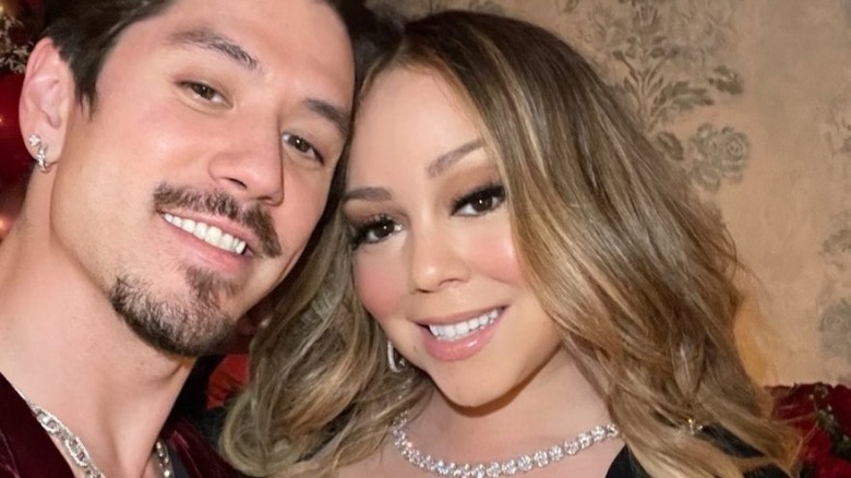 Bryan Tanaka and Mariah Carey smile in a selfie