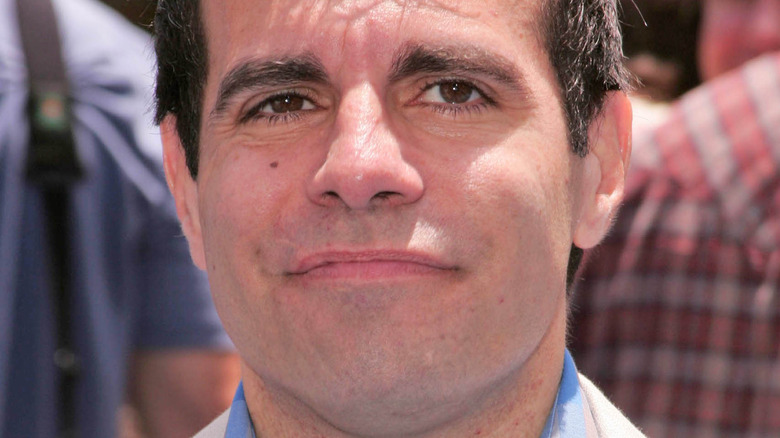 Mario Cantone sort of smiling