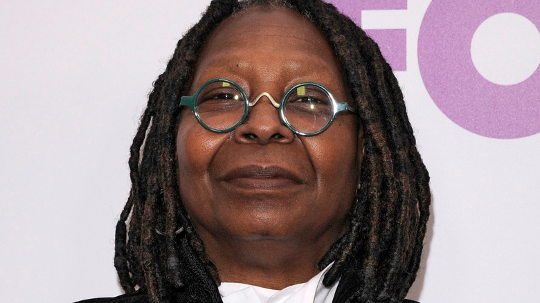 Whoopi Goldberg grins on the red carpet