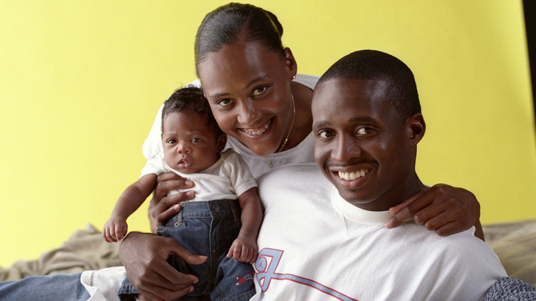 Marion Jones posing with Tim Montgomery and their son