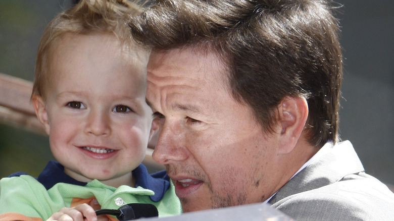 Mark Wahlberg holding Brendan Wahlberg