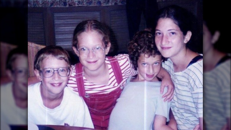 Mark Zuckerberg posing with his sisters