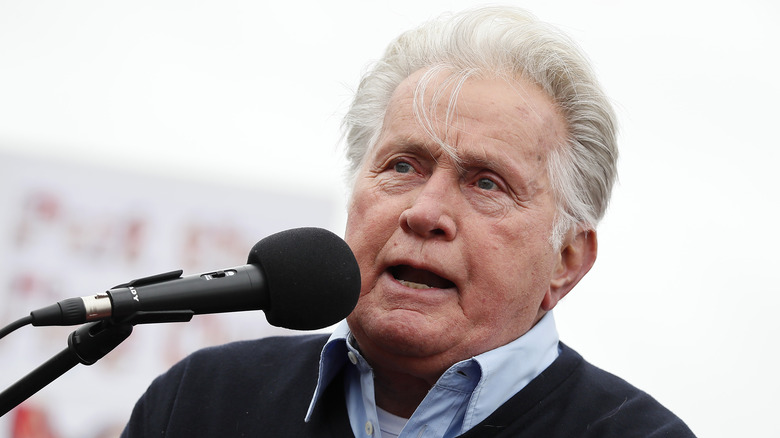 Martin Sheen speaks into microphone