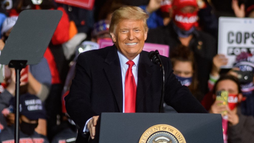 Donald Trump smiling at a podium