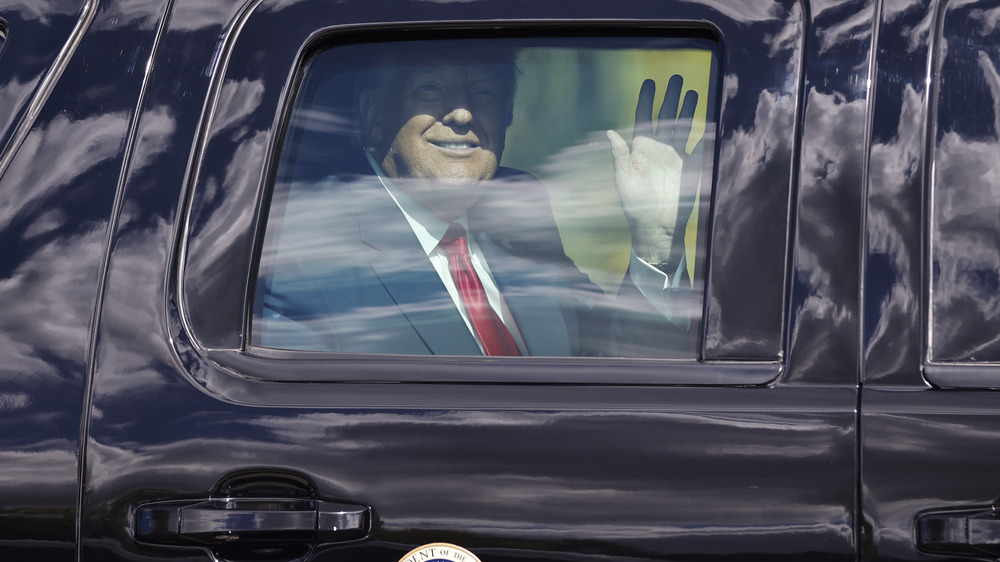 Donald Trump waving from car