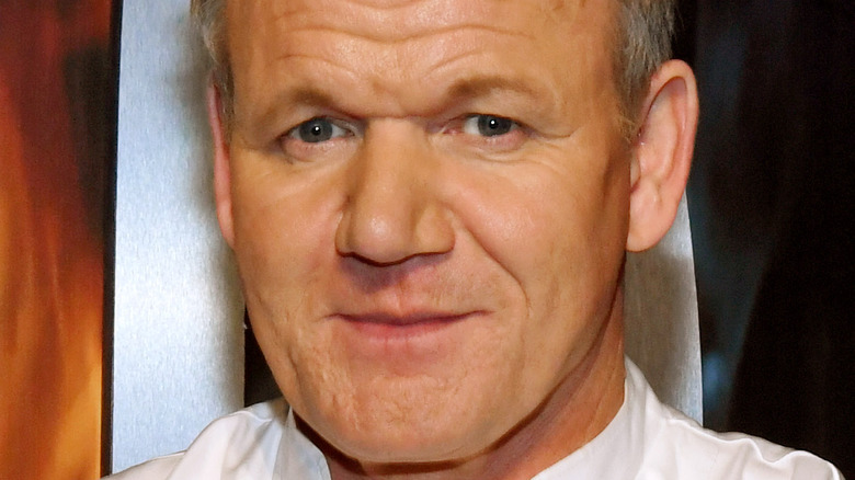 Gordon Ramsey smirks at an event