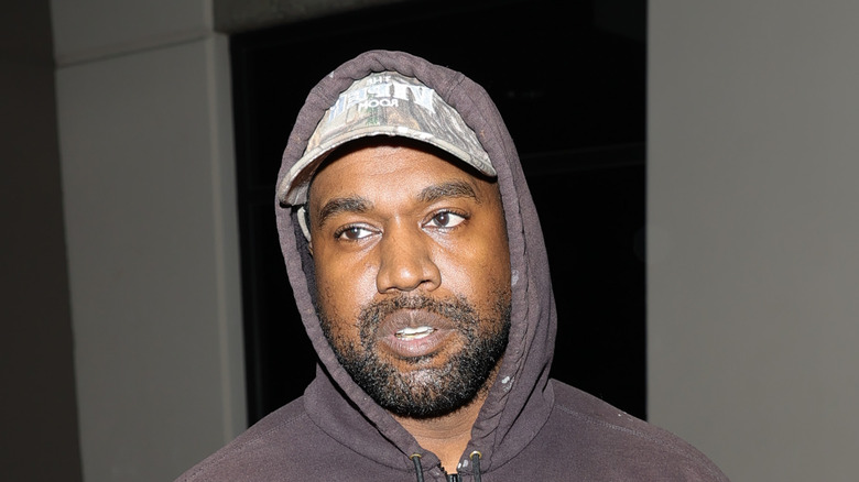 Kanye "Ye" West with hoodie and hat