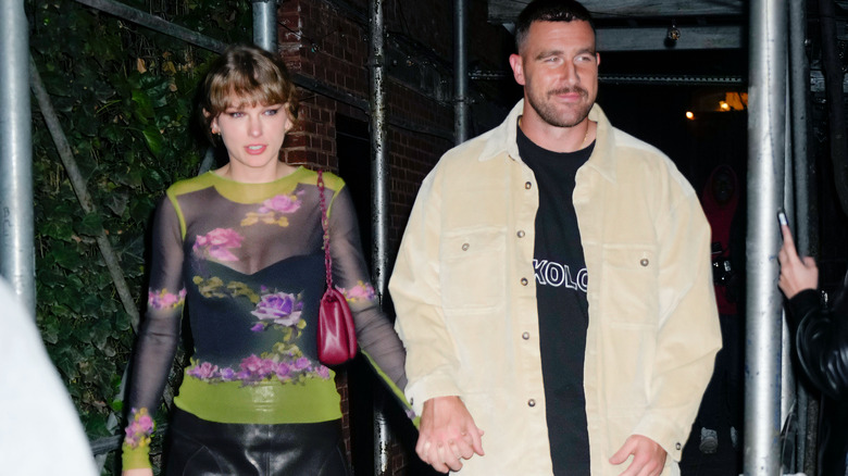 Taylor Swift and Travis Kelce holding hands