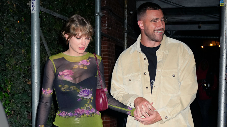 Taylor Swift and Travis Kelce hold hands