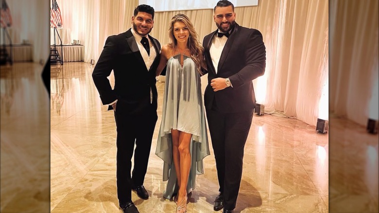 Ginger Gaetz posing with two men in tuxedos