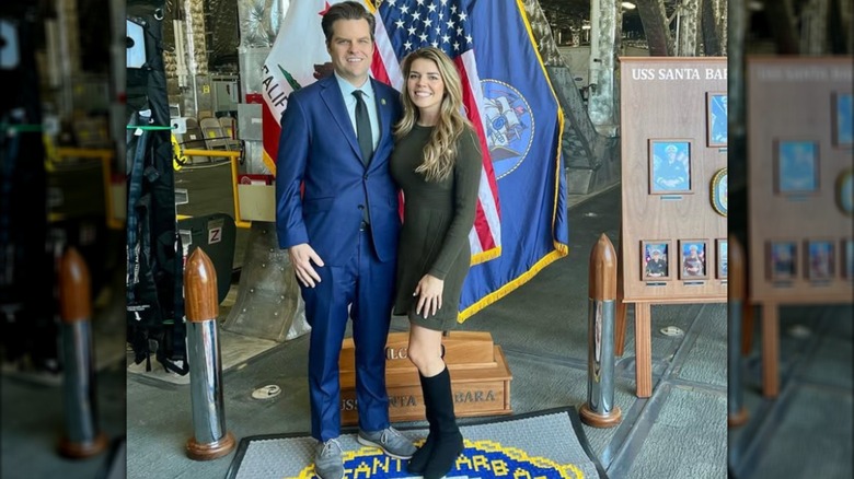 Matt and Ginger Gaetz pose in front of flags