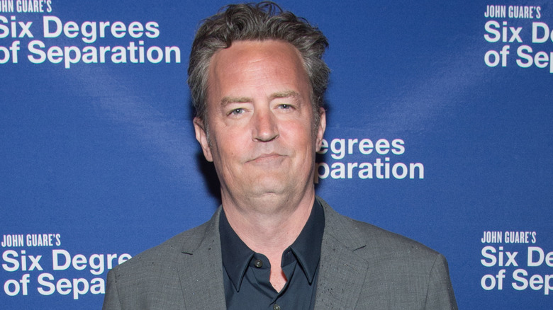 Matthew Perry wearing gray blazer