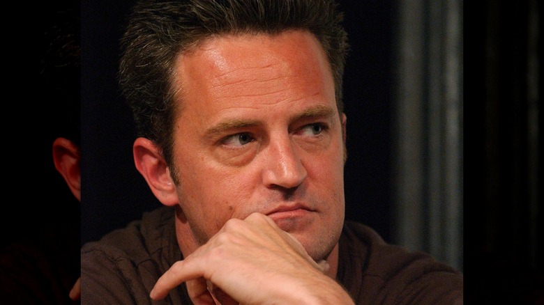 Matthew Perry resting chin on hand