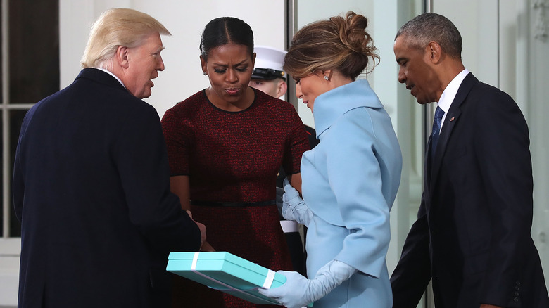 Michelle Obama recieving gift from Melania Trump