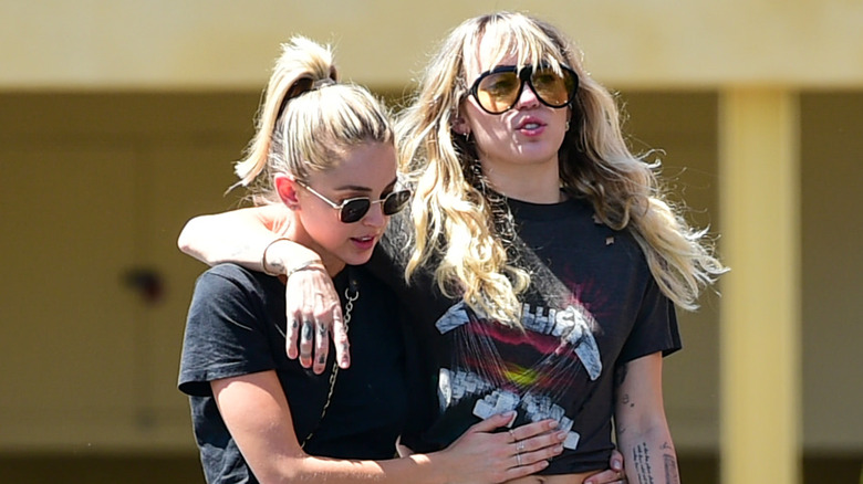 Miley Cyrus and Kaitlynn Carter walking together 