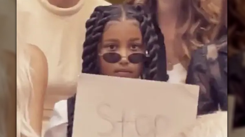 North West holding a sign 