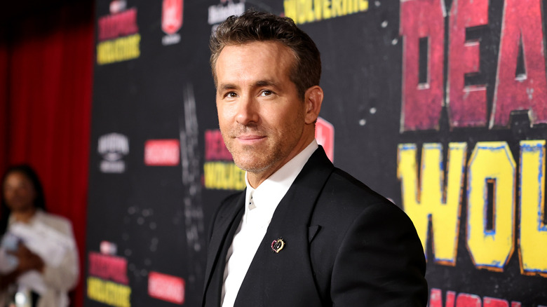 Ryan Reynolds wearing a black jacket and white collared shirt at Deadpool and Wolverine premiere