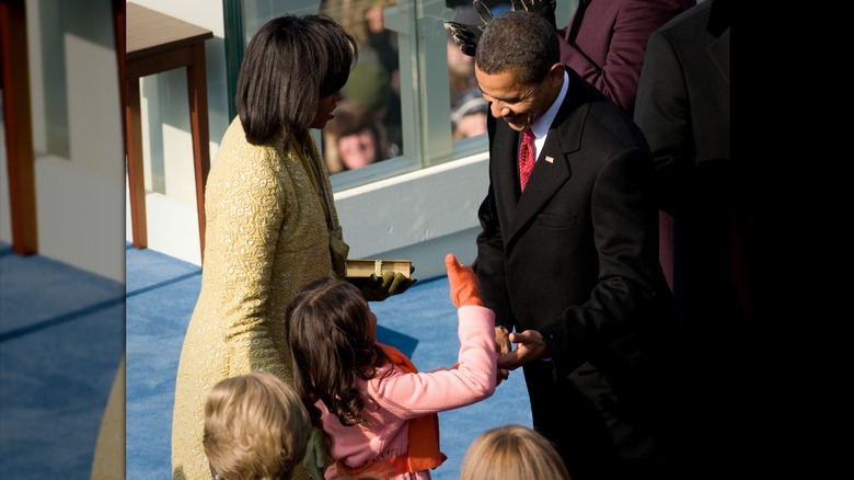 Sasha Obama giving her father a thumbs up