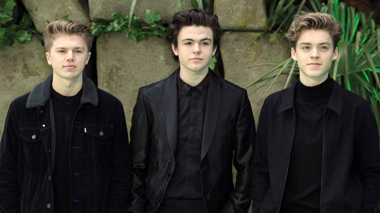 Blake Richardson in black flanked by the other two members of New Hope Club in 2018