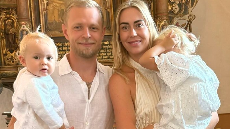 Louise Gjørup standing with Kevin Magnussen and their two children