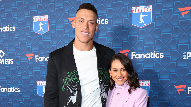 Aaron Judge posing with wife Samantha Bracksieck on red carpet