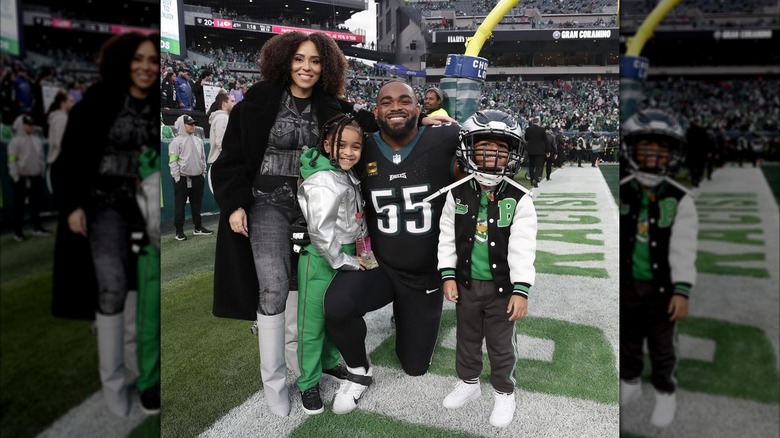 Carlyne and Brandon on the field with their kids