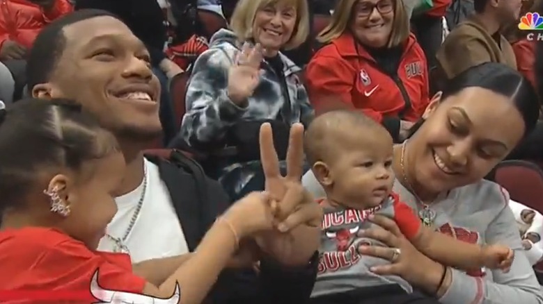 D.J. Raven Moore and kids at NBA game