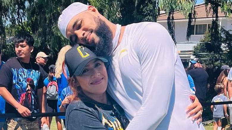 Keenan Allen embracing Ciandra Monique hugging outdoors