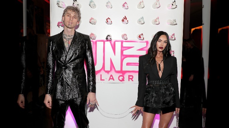 Machine Gun Kelly and Megan Fox chained by their nails